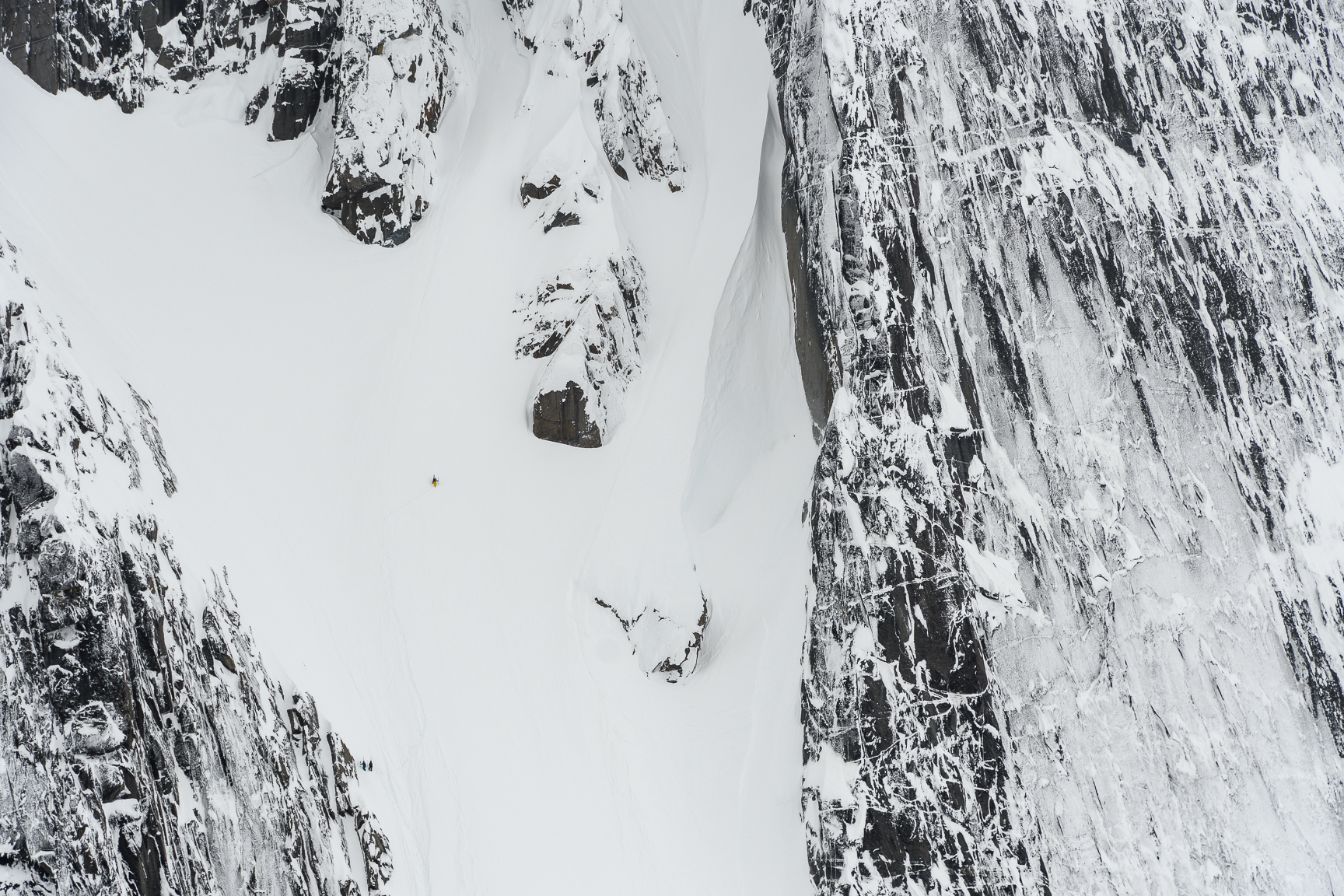 Tom dwarfed by the couloir - copyright Fred Marmsater