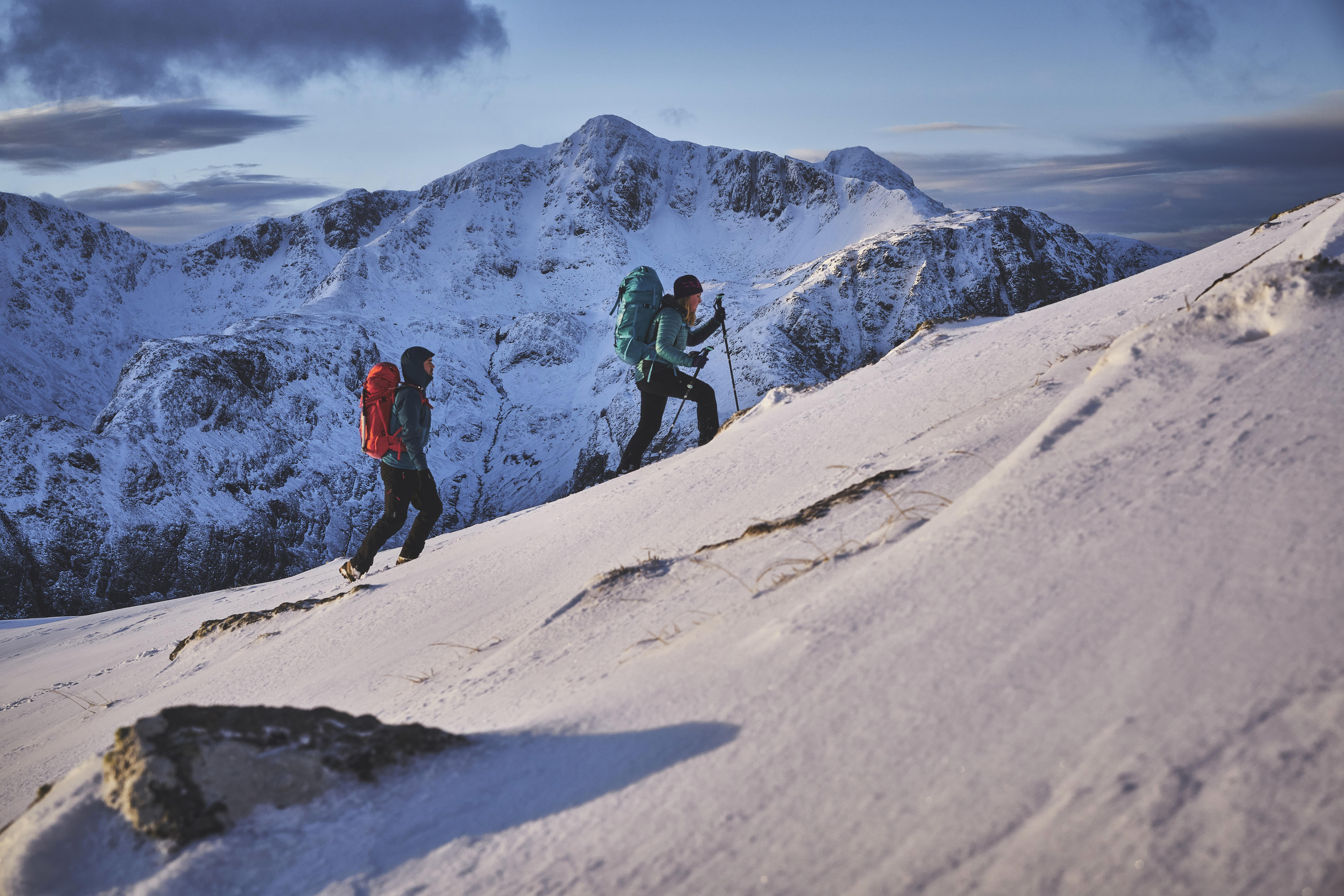 Two walkers climbing up Am Bodach with Stob Coire nan Lochan behind them
