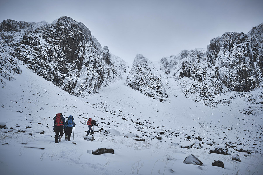 Three climbers approaching the cliffs of Stob Coire nan Lochan